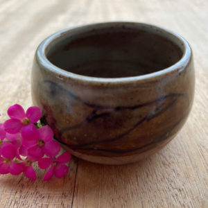 Brown ceramic teacup